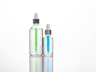 transparent dropper bottle with white bottom and colored dropper