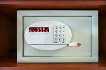 A safe with a numeric keypad show a bright red CLOSED message. The setting suggest it is designed...