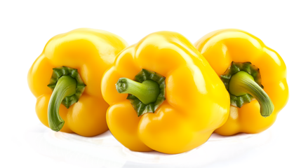 Three yellow peppers are sitting on a white plate. The peppers are all the same size and shape, and they are all pointing in the same direction. The image has a bright and cheerful mood