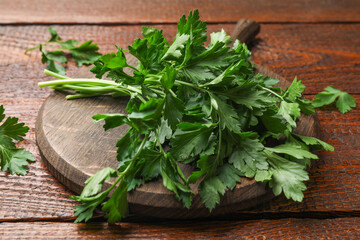 Bunch of fresh parsley on wooden table, closeup