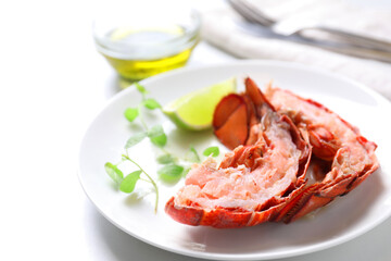 Delicious boiled lobster served on white table, closeup