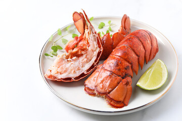 Delicious tails of boiled lobsters served on white table, closeup