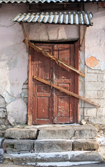 Boarded up wooden door in an old abandoned house