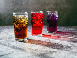 A lot of Soft drinks in colorful and flavorful glasses on the table,Glasses with sweet drinks with ice cubesv