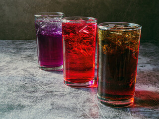 A lot of Soft drinks in colorful and flavorful glasses on the table,Glasses with sweet drinks with ice cubesv