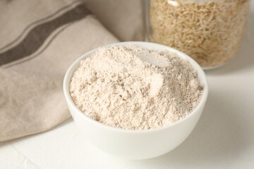 Brown rice and flour on white table, closeup
