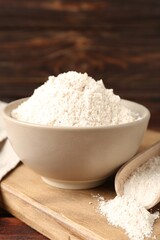 Brown rice flour on wooden table, closeup