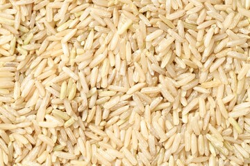 Pile of brown rice as background, top view