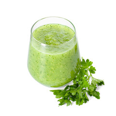 Healthy parsley smoothie in glass and leaves isolated on white
