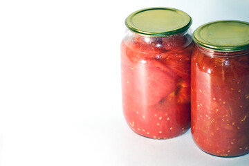 Canned sour tomatoes in glass jars. Pickled tomatoes in a jar.