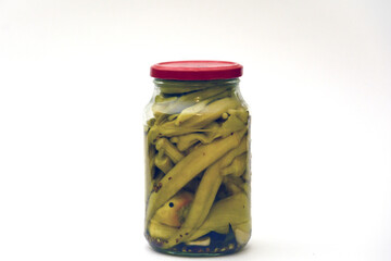 Canned sour okra in glass jars. Pickled okra in a jar.