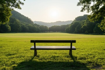 Fototapeta premium Serene bench in a lush park with sunrise over green hills and trees