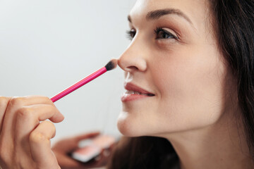 Makeup artist doing makeup on a young woman