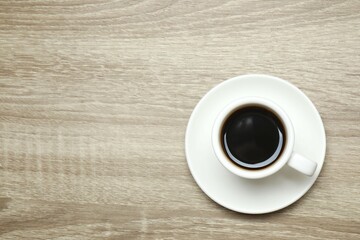 Cup of coffee on wooden background