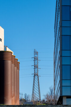 Modern urban architecture with high-rise glass buildings and geometric structures in a contemporary cityscape, showcasing minimalist design and clean lines.