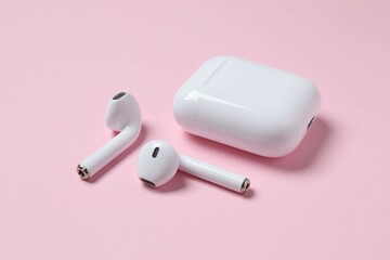 Wireless ear phones with a white box on color background 