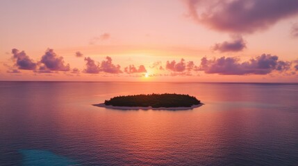 Sunset over a lonely island in the sea, with a pink and orange sky