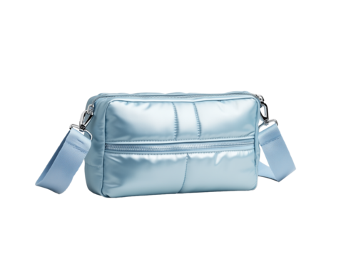 A stylish, sky blue, quilted bag, featuring a convenient zippered compartment and an adjustable strap for versatile carrying options. Isolated, transparent background, png.