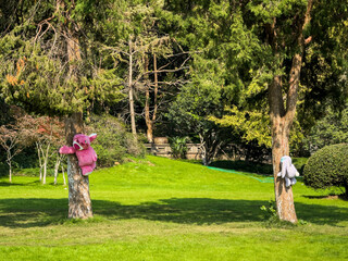 Fototapeta premium Playful Teddy Bears Climbing Trees in a Lush Green Park