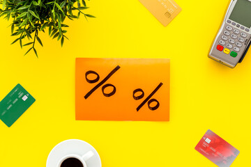 Sales concept with discount sing. Online shopping - table with POS payment terminal and credit cards, top view