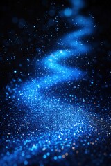 Captivating Blue Glitter Cascade on Dark Surface Creates a Mesmerizing Abstract Background with Sparkling Lights and Bokeh Effect