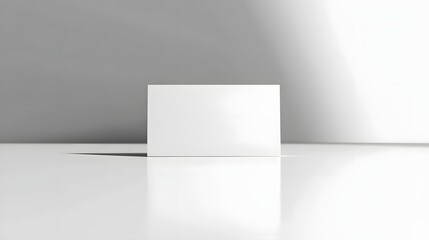 Blank White Business Card Standing on Smooth White Surface with Crisp Edges and Bright Lighting