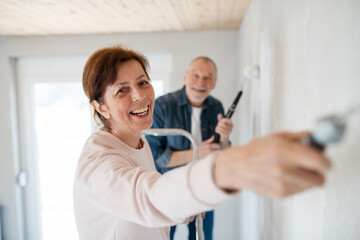 Senior couple renovating their home, a shared retirement activity.