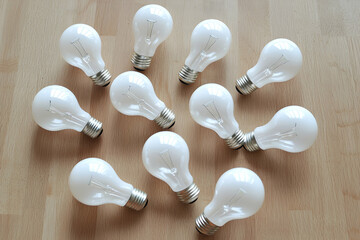 Wooden Surface with Light Bulbs, creating an artistic and creative visual perfect for conveying new ideas and innovation.