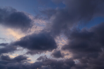 Dark clouds in the pink light of the setting sun gather on the horizon, heralding the approach of rain. Symbolizes upcoming challenges and inner strength.