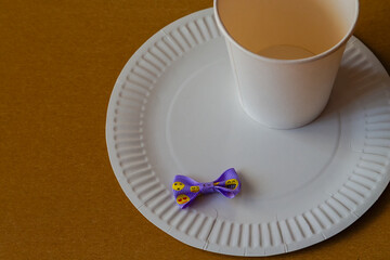 Disposable tableware and a small funny ribbon – a simple yet important attribute of a birthday at work, a blend of light sadness and joy of the moment.