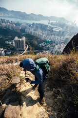 Hiker climbing up on the mountain trail in Hong Kong