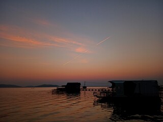 Evening sky by the river, floating raft in the middle of the water