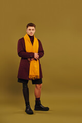 Handsome young man with prosthetic leg showcases trendy fashion in studio setting