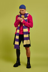 Fashionable young man with prosthetic leg showcases trendy style in studio setting