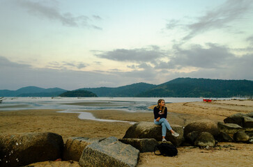 woman sitting on a rock