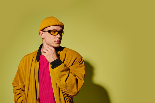 Stylish young model showcasing trendy attire against a vibrant backdrop in studio - Powered by Adobe