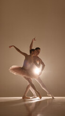 Duo executes intricate lift with poise, delicate costumes and body tension creating striking...