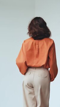 Minimalism and avant-garde in motion: a woman in an elegant outfit walks, her hair in motion, a sleek and modern aesthetic. Perfect for fashion campaigns and luxury branding.