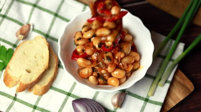 Pour into a plate lobio. Lobio is a dish of Georgian, Azerbaijani and Armenian cuisines made from green bean pods. Traditional Georgian cuisine lobio. Lean dish. Lobio with pepper, onion.