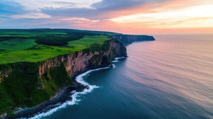 Seaside cliffs landscapes concept. Stunning aerial view of cliffs meeting the tranquil ocean at sunset.