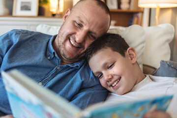 Obraz premium Father, boy and smile with care, fantasy and relax with love, literature or learning in living room.