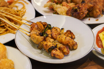 Indonesian satay, captured on March 17, 2025. Grilled skewered meat coated in rich spices and served with savory peanut sauce, creating a flavorful and authentic dish
