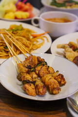 Indonesian satay, captured on March 17, 2025. Grilled skewered meat coated in rich spices and served with savory peanut sauce, creating a flavorful and authentic dish