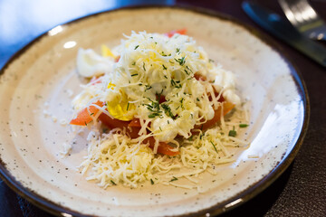 Plate with a mix of tomatoes, cheese, eggs with french sauce