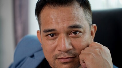 Asian Businessman show his face with emotion in Modern Office