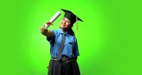 Indian Asian teenage girl in school uniform wearing a graduation hat, happily holding a certificate roll, celebrating academic success while standing against a green chroma screen