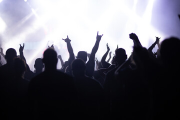Crowd at concert and blurred stage lights.