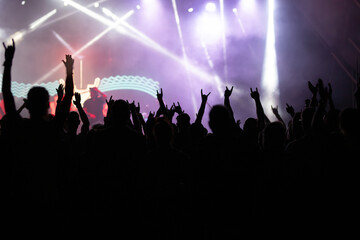 Crowd at concert and blurred stage lights.
