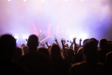 Crowd at concert and blurred stage lights.