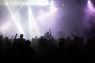 Crowd at concert and blurred stage lights.